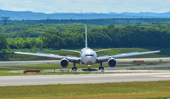 Sapporo, Japan - Jul 3, 2019. Passenger airplane taxiing on runway of New Chitose Airport (CTS) in Sapporo, Japan.