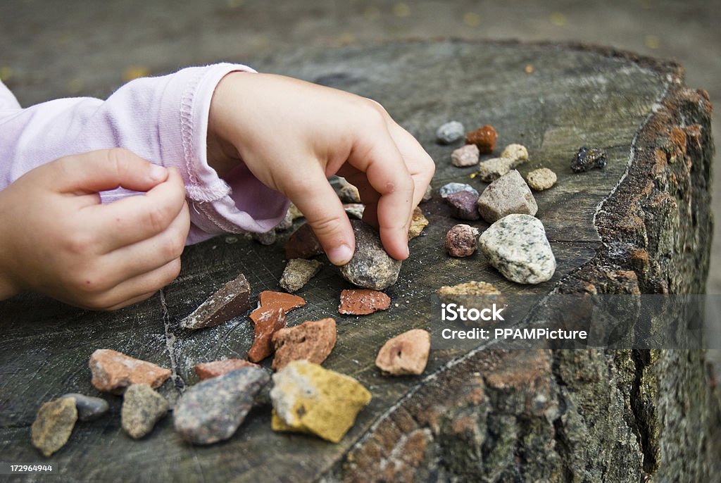 Stones Child is playing with stones Child Stock Photo