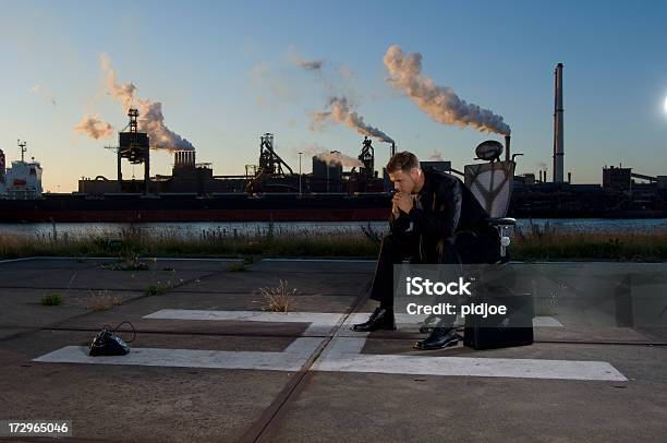 Thinking Businessman On Helipad In Industrial Environment Stock Photo - Download Image Now