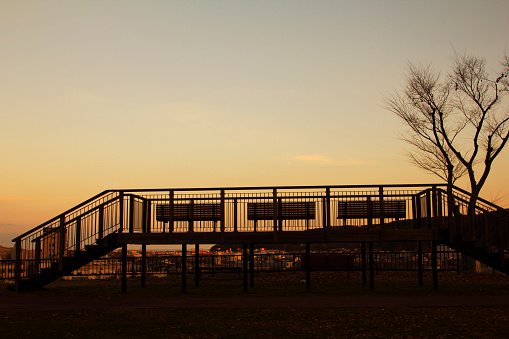 The city view point has many benches, empty, giving the atmosphere of sunset. Silhouette Photo. At Observatory Tatsumiyama Park, Iwate, Japan