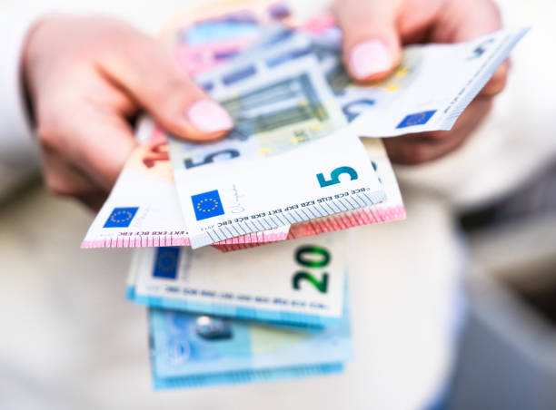 Holding collection of Euro banknotes