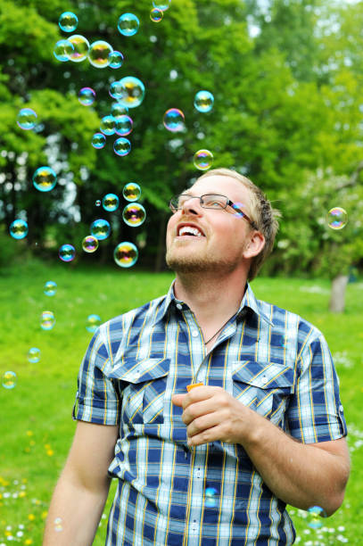 istock Man blowing bubbles outdoors 172965532