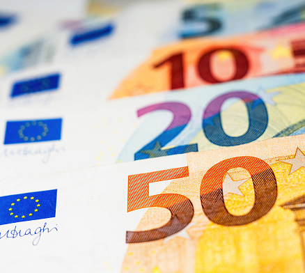 Close-up on the large numbers on five, ten, twenty and fifty Euro banknotes.