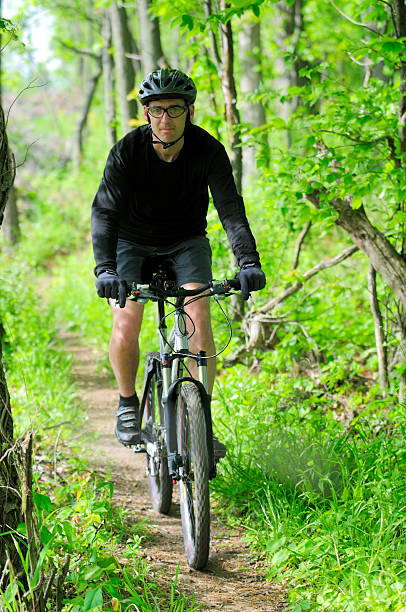 istock Mountain biker riding in the woods. 172965539