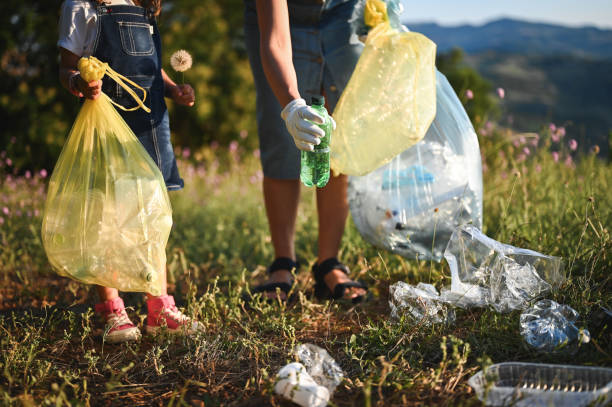 istock family collecting garbage and wastes in plastic bag. 1729656837