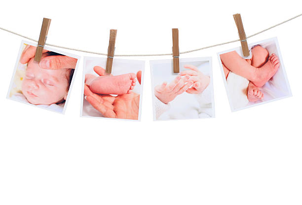 Four photographs of a newborn hanging on the clothesline stock photo