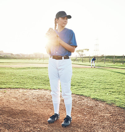 Baseball, pitcher and sports person outdoor on a pitch for performance and competition. Professional athlete or softball woman thinking of a game, training or exercise challenge at field or stadium