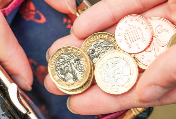istock Putting coins in a purse 1729659779