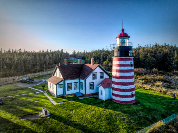 The Unique West Quoddy Head Lighthouse in Maine West Quoddy Head, in Quoddy Head State Park, Lubec, Maine, is the easternmost point of the contiguous United States.  In 1808 a lighthouse was constructed at the site to guide ships. quoddy head state park stock pictures, royalty-free photos & images