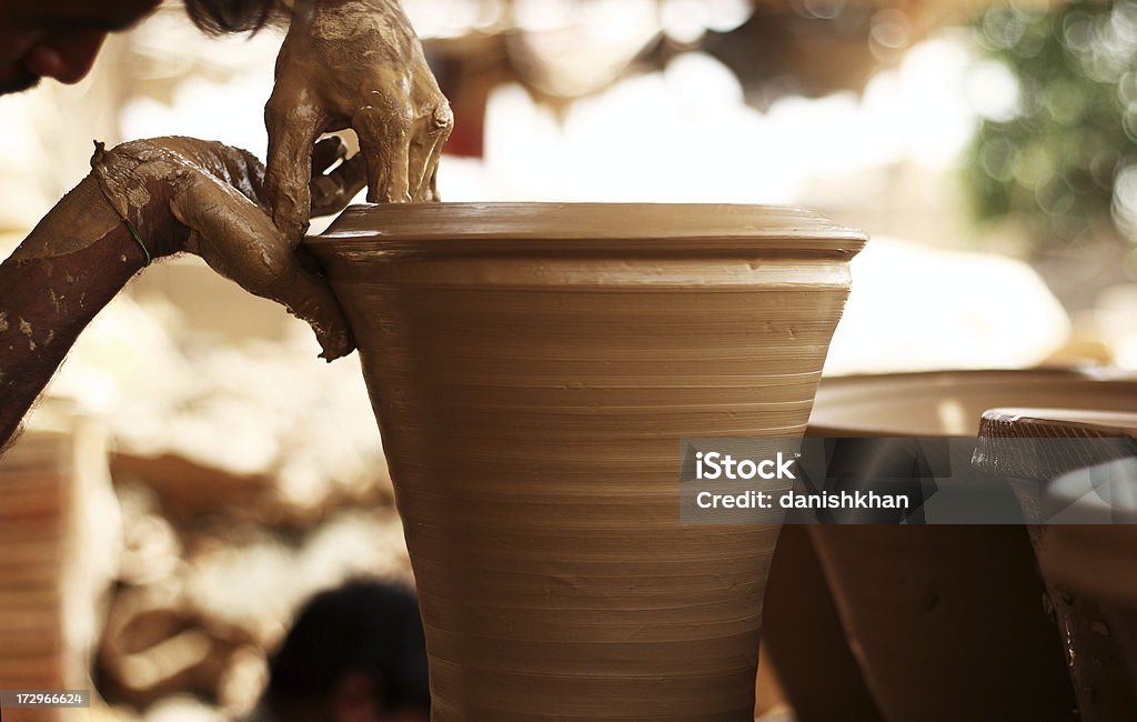 Finishing Touch A potter is crafting plant pots with clay. Pakistan Stock Photo