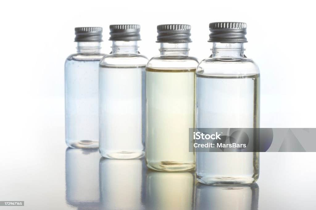 backlit toiletry bottles transparent toiletry bottles on white background. Focus on the front one. You may also like: Aromatherapy Oil Stock Photo