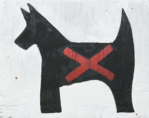 Hand-painted sign of a little black dog marked with a red x