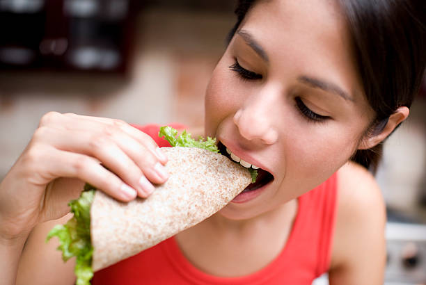 Woman eating a taco