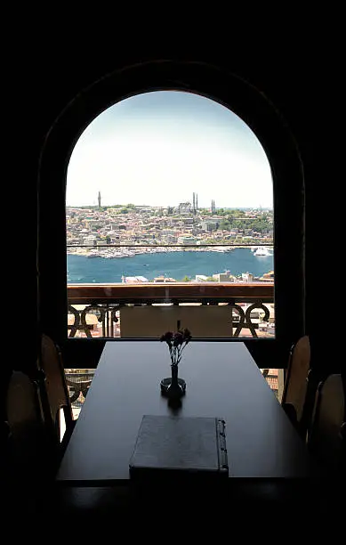 A Table and chairs of a restaurant with the view of golden horn in Istanbul.