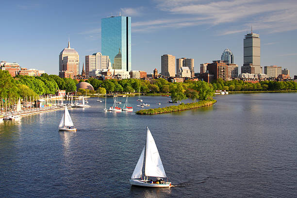 Boston Sailboats on the Charles River with Boston's Back Bay skyline in the background. Boston is the largest city in New England, the capital of the state of Massachusetts. Boston is known for its central role in American history,world-class educational institutions, cultural facilities, and champion sports franchises. charles river stock pictures, royalty-free photos & images