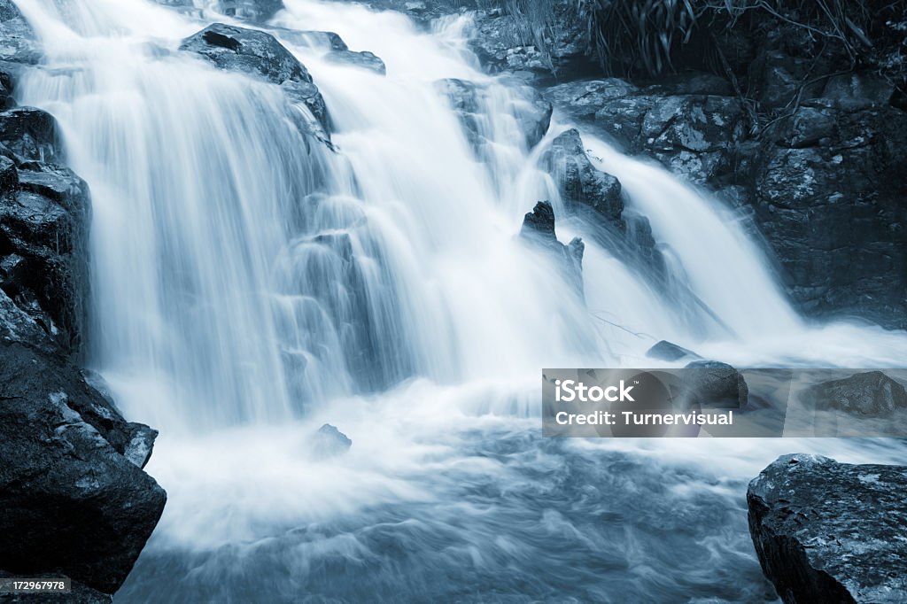 Peaceful Waterfall Cool water streaming down into a rocky pond. Waterfall Stock Photo