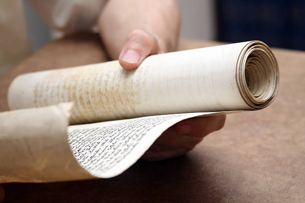 Ancient Scroll "Holding an ancient scroll, selective focus" torah photos stock pictures, royalty-free photos & images