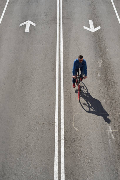 istock From above, young man ride his bicycle on roadway 1729687552