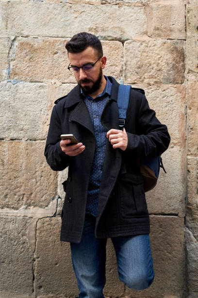 istock young man using his smartphone in the street 1729688649