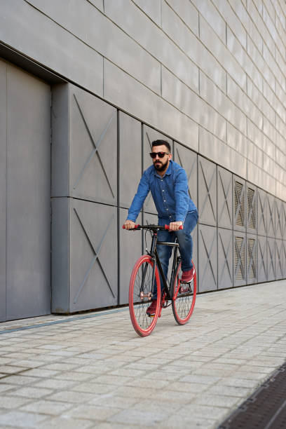 istock Young man riding a bicycle outdoors 1729690765