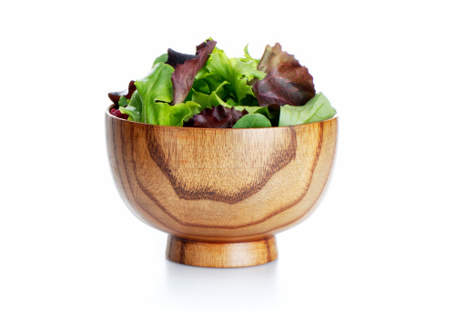 Salad mix in wooden bowl, isolated on white. More in lightbox...