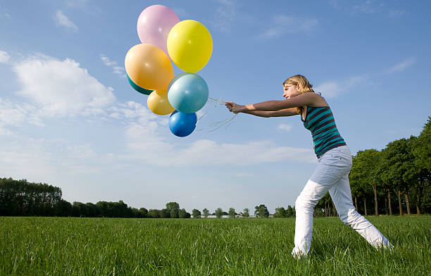 istock young girl playing with balloons 172969560