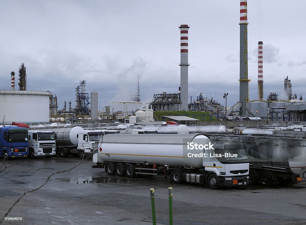 Trucks and Oil Refinery Trucks and refinery in a foggy and rainy day Truck Stock Photo