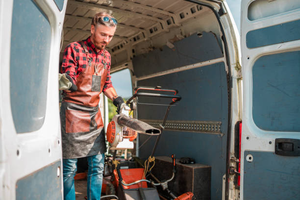 istock Gardener in Apron and Protective Gloves Unloading Gardening Tools from Van in Garden Center 1729699726