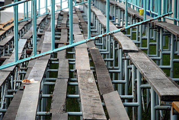 Abandoned Bleachers Empty bleachers with one untouched meal left behind. wooden bleachers stock pictures, royalty-free photos & images