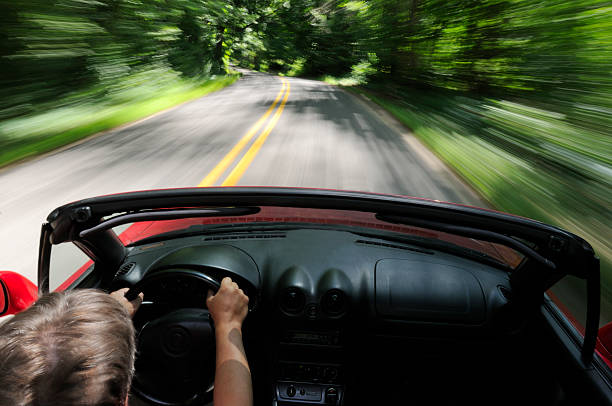 istock Man driving a convertible in a scenic road 172970891