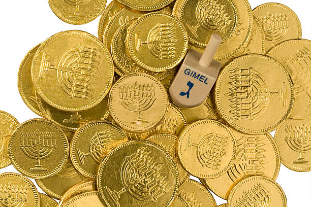 Dreidel and Hanukkah gelt isolated on white. [/url]