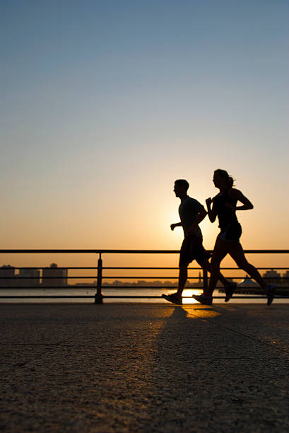 istock Golden Sunrise Jogging Couple Silhouette 172971214