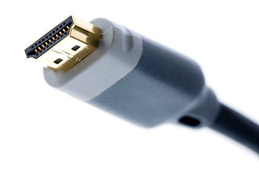 White network cable patch-cord on gray textured background close up