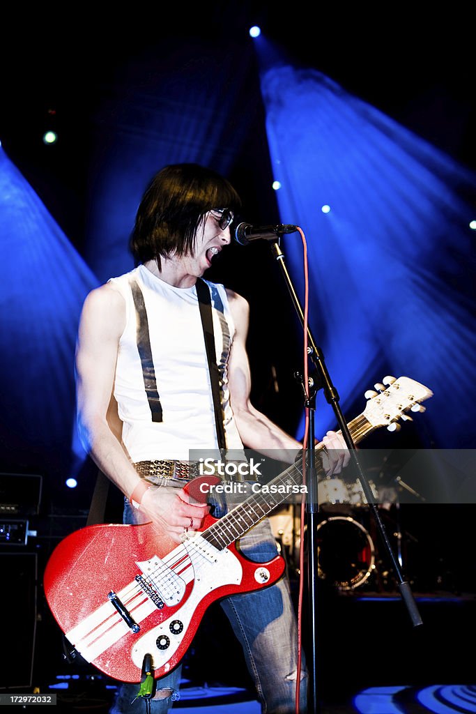 Punk Rock Star Young guitarist in a punkrock band on stage (sync on second curtain, Still image and motion blur present) 20-24 Years Stock Photo