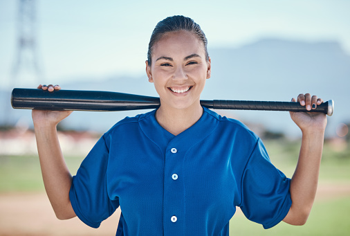 Sports, portrait and woman with a baseball, bat and smile at a field for training, workout or match practice. Happy, face and female softball batter at a park for competition, performance and workout