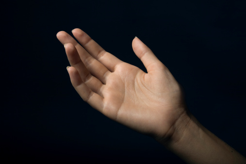 Above view and closeup of two hands extended with open palms in a giving and receiving gesture. Unknown mixed race businesswoman asking for help. Hispanic office professional offering support