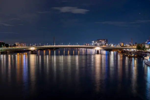Evening view of the Deutz Bridge in Cologne, lights reflected in the Rhine