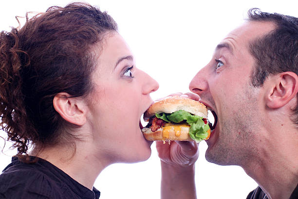 People eating juicy burger stock photo
