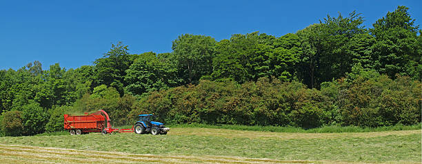 A panoramic view of a tractor collecting grass for silage Polorizing filter used