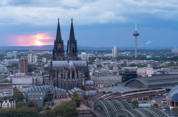 istock Dramatic storm clouds over Cologne Cathedral and Hohenzollern Bridge in the sunset 1729729548