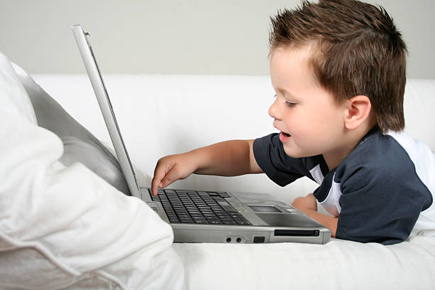 istock little boy playing on a laptop 172973073