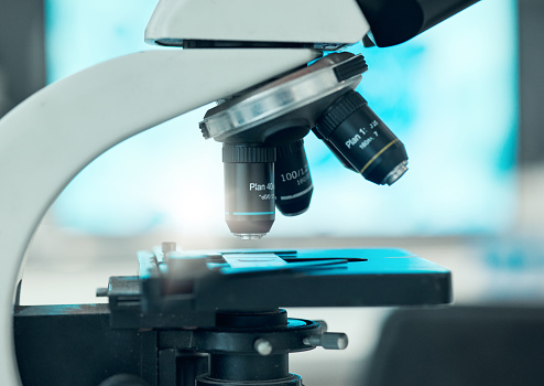 Science, closeup and a microscope for research of bacteria, studying medicine or dna in a lab. Healthcare, gear or equipment for medical analytics, pharmaceutical investigation or biotechnology