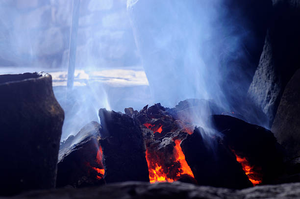 Close-up of a smokey peat fire A smouldering peat fire as used by ancient people to heat their dwelling and cook. Peat stock pictures, royalty-free photos & images