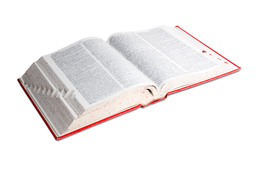 A red cover dictionary sits open, isolated on a white background.