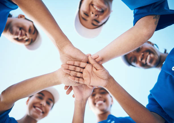 sports, hands and portrait of baseball women below for support, teamwork and goal collaboration. fitness, face and friends palm together for softball training, commitment or motivation or celebration - exercising motivation looking up african descent imagens e fotografias de stock