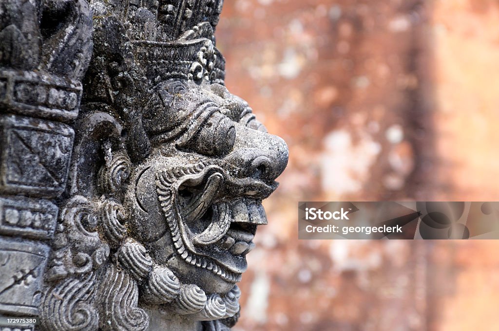 Hindu Temple Statue An ancient stone carving at a temple in Ubud, Bali in Indonesia. Ancient Stock Photo