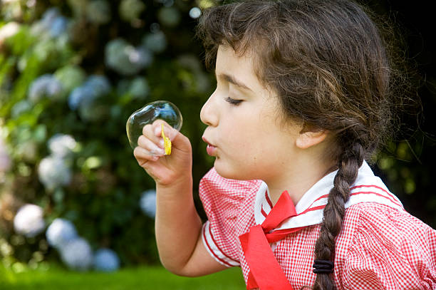 istock Little girl blowing big bubble 172975513