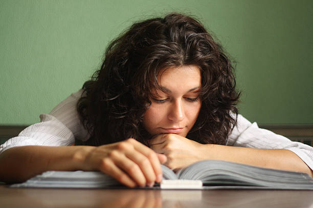 Girl student reading a book stock photo