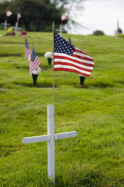 istock Memorial with white cross and US flag 172975837