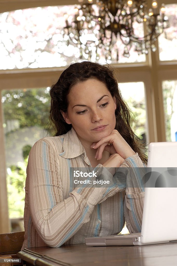 Jeune femme à la recherche à un ordinateur portable - Photo de Adulte libre de droits